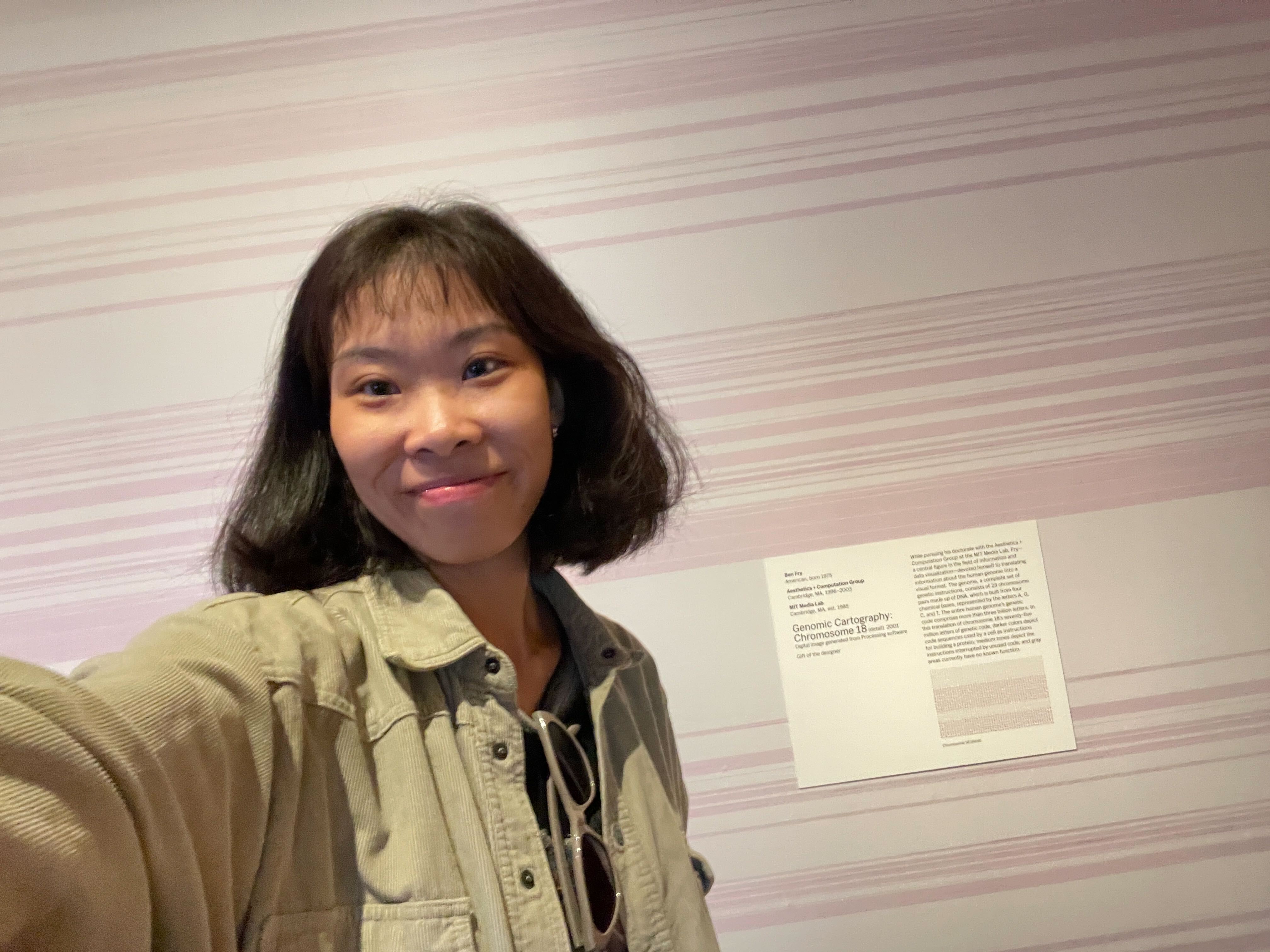 Karlie in front of the exhibit wall